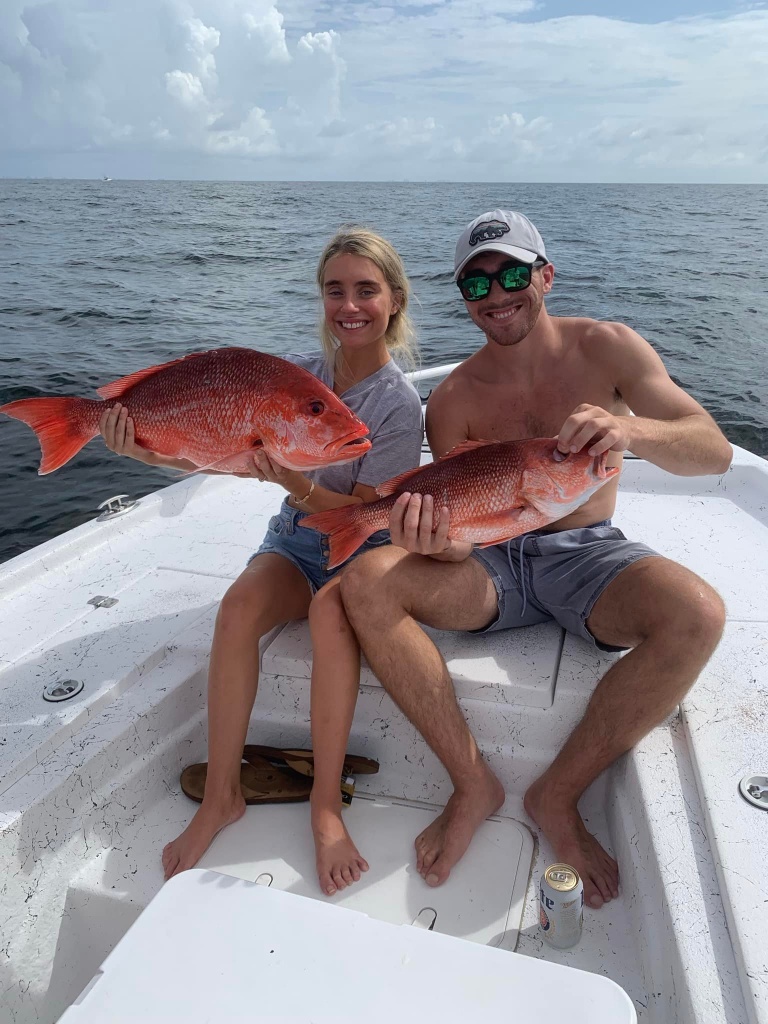 Two people fishing with big fish at Orange Beach