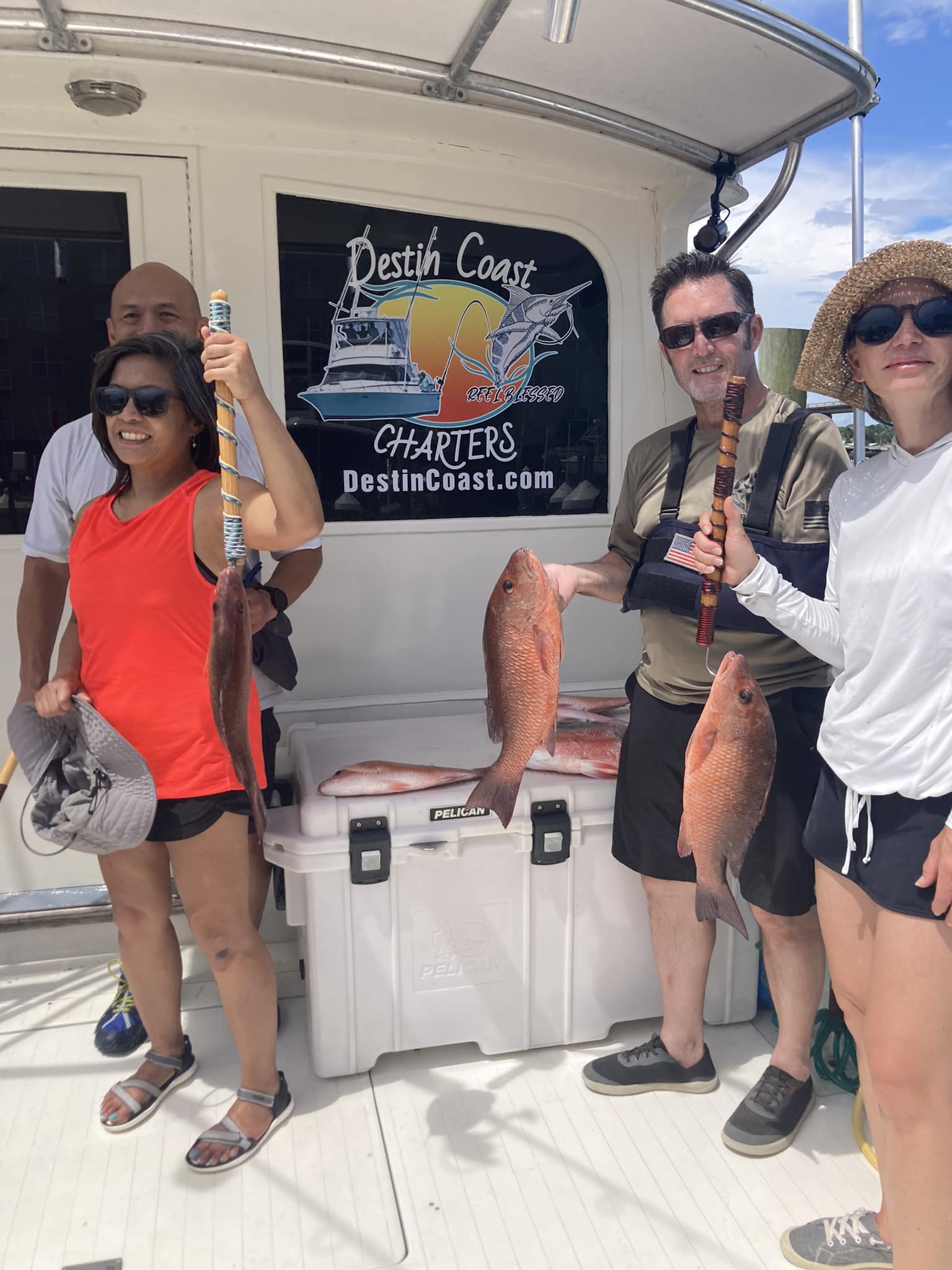 4 people fishing with 2 fish at Fort Walton Beach