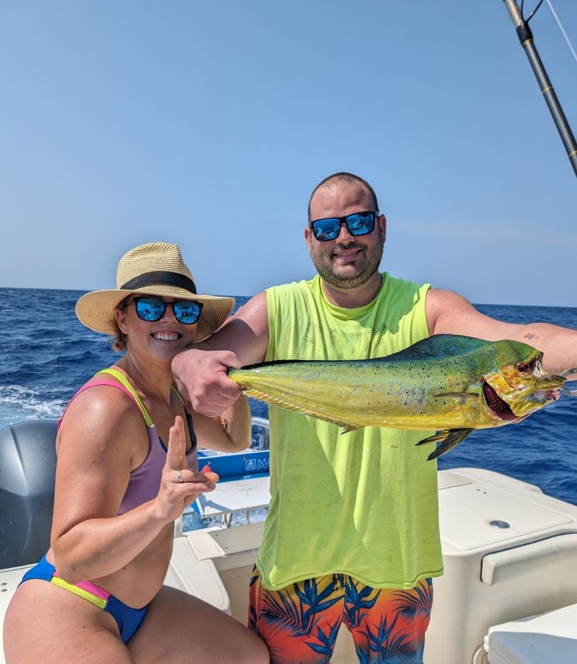 Florida Keys reef fishing and snorkeling boat trip with guests catching snapper and mackerel