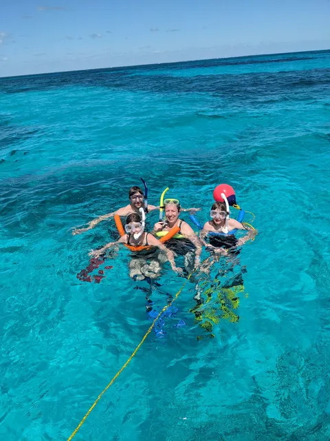 Florida Keys snorkeling group exploring coral reef with tropical fish in crystal clear waters