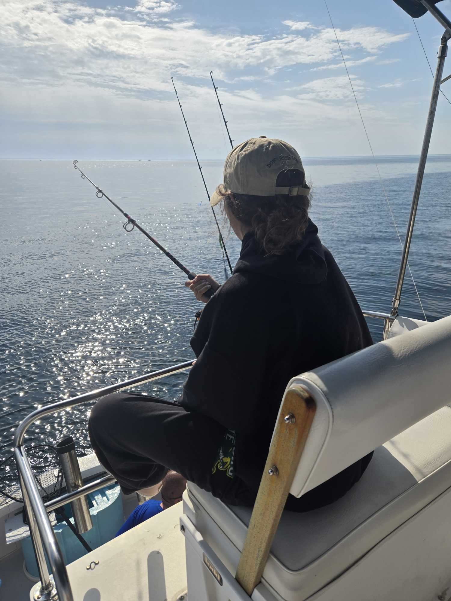 Fishing from boat on ocean waters off Cape Cod MA with fishing rods set up
