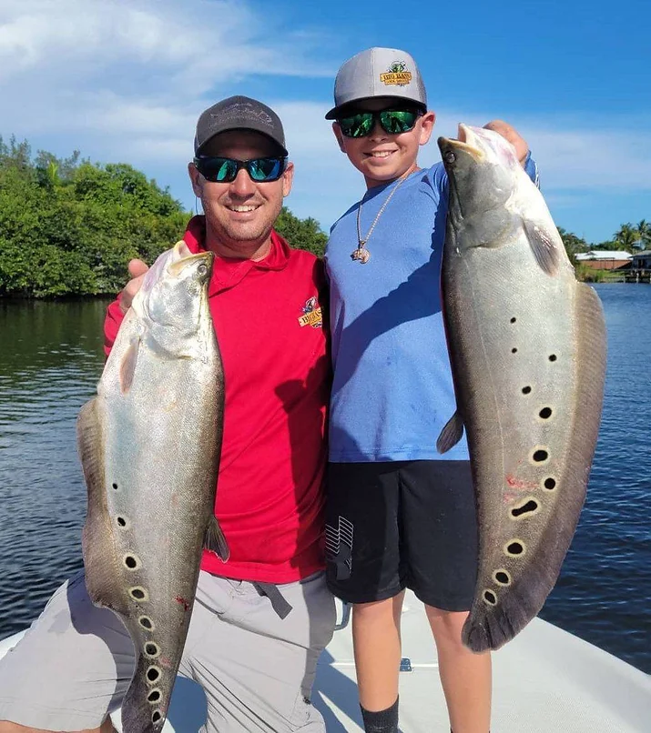 Two anglers with a big 28-inch catch in Florida