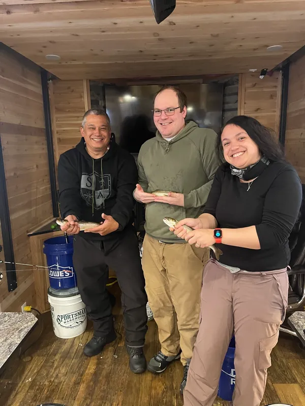 Three people fishing at the North Pole