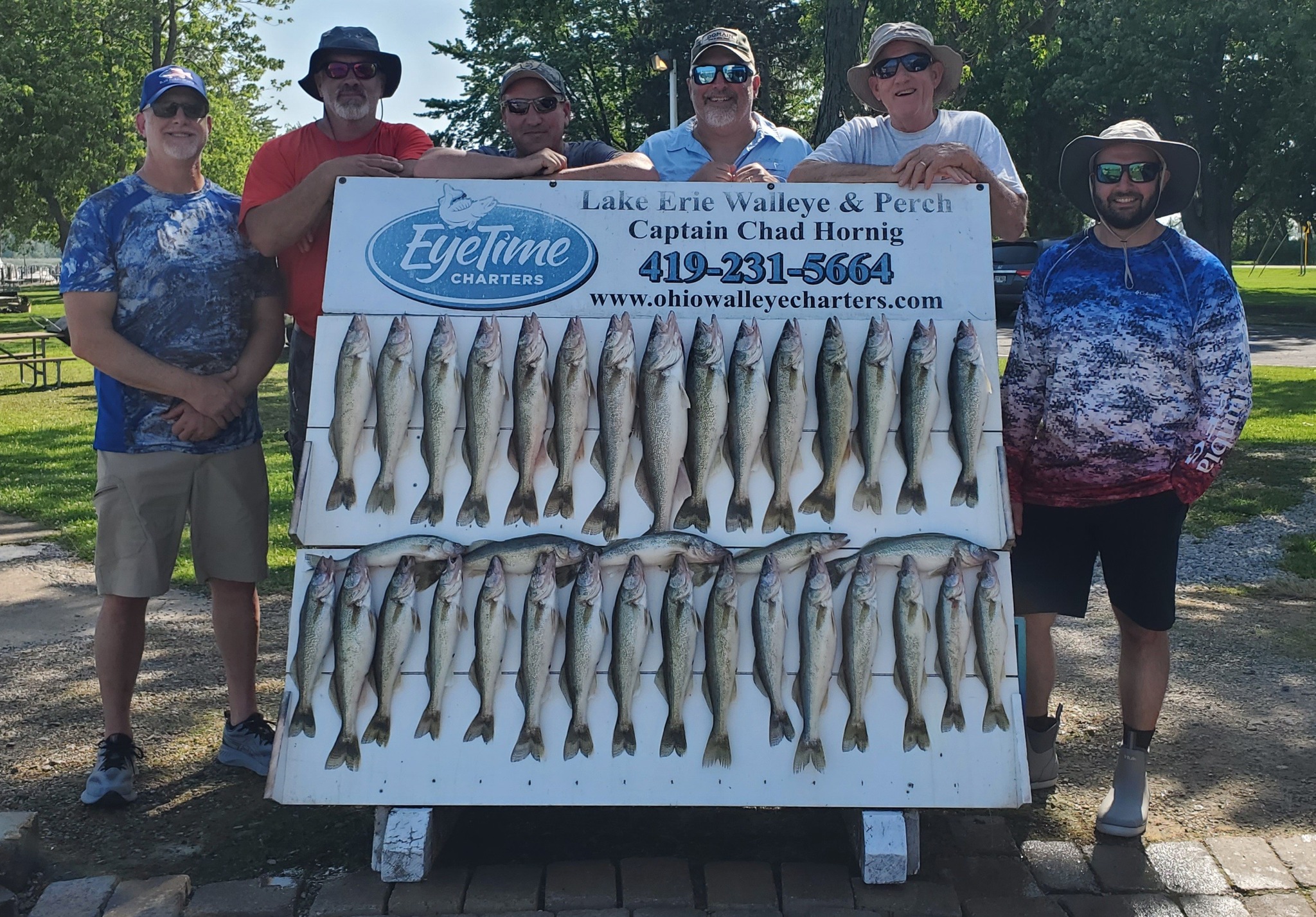 A group of 6 people fishing at the lakeside in Marblehead