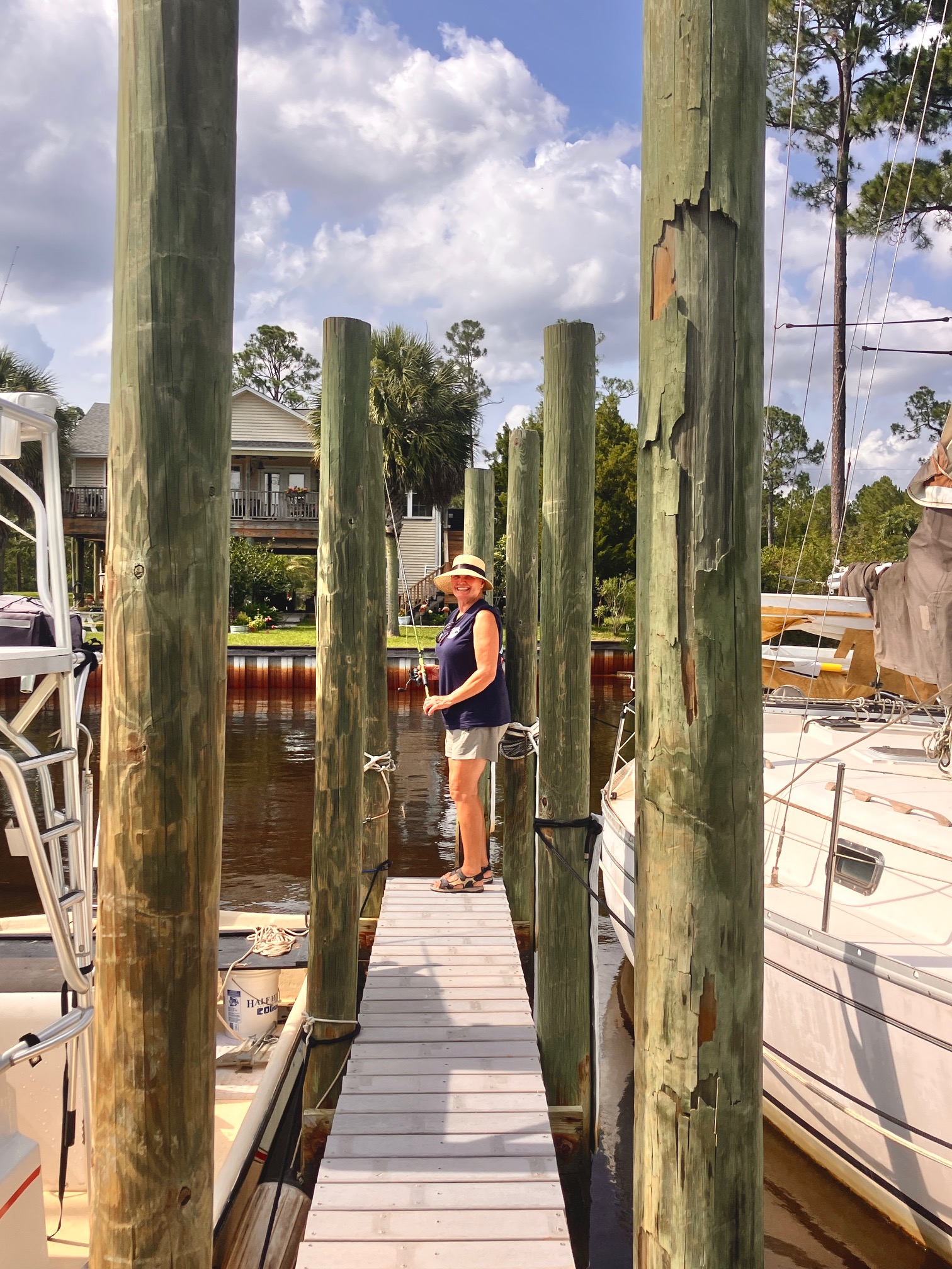 Marina dock with wooden pilings and boats in Bagdad FL