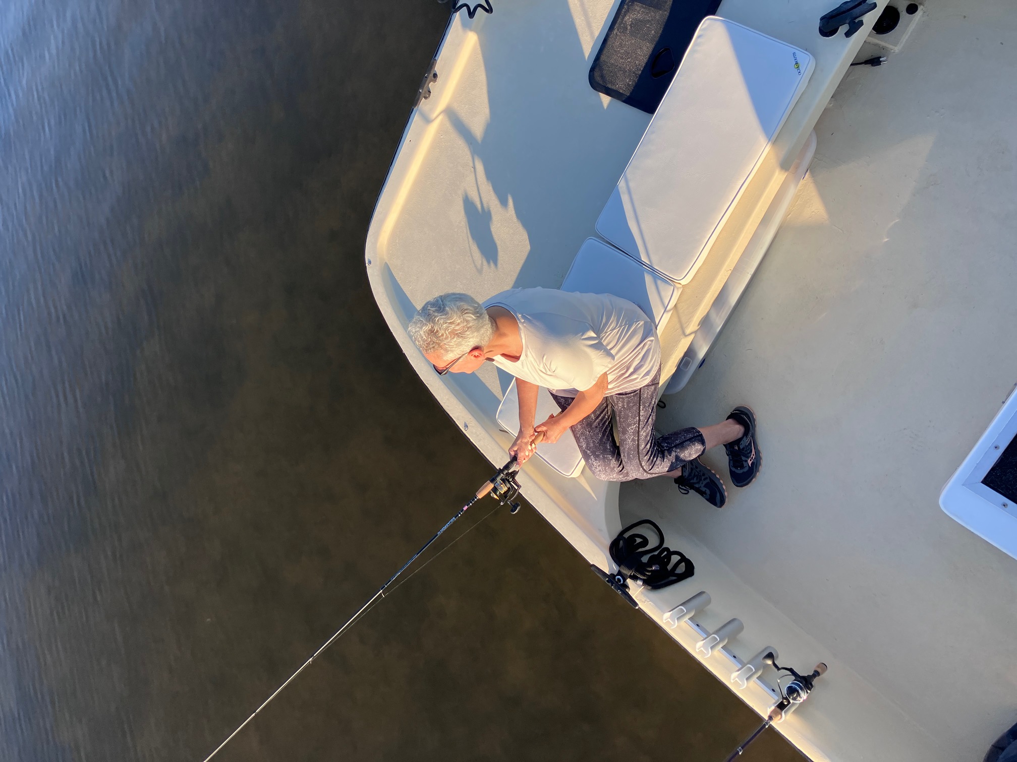 Fishing from white boat on calm waters near Bagdad FL