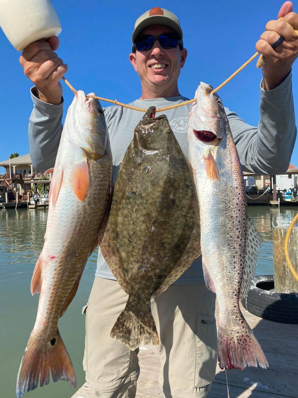 Three spotted weakfish and European flounder caught fishing at South Padre Island