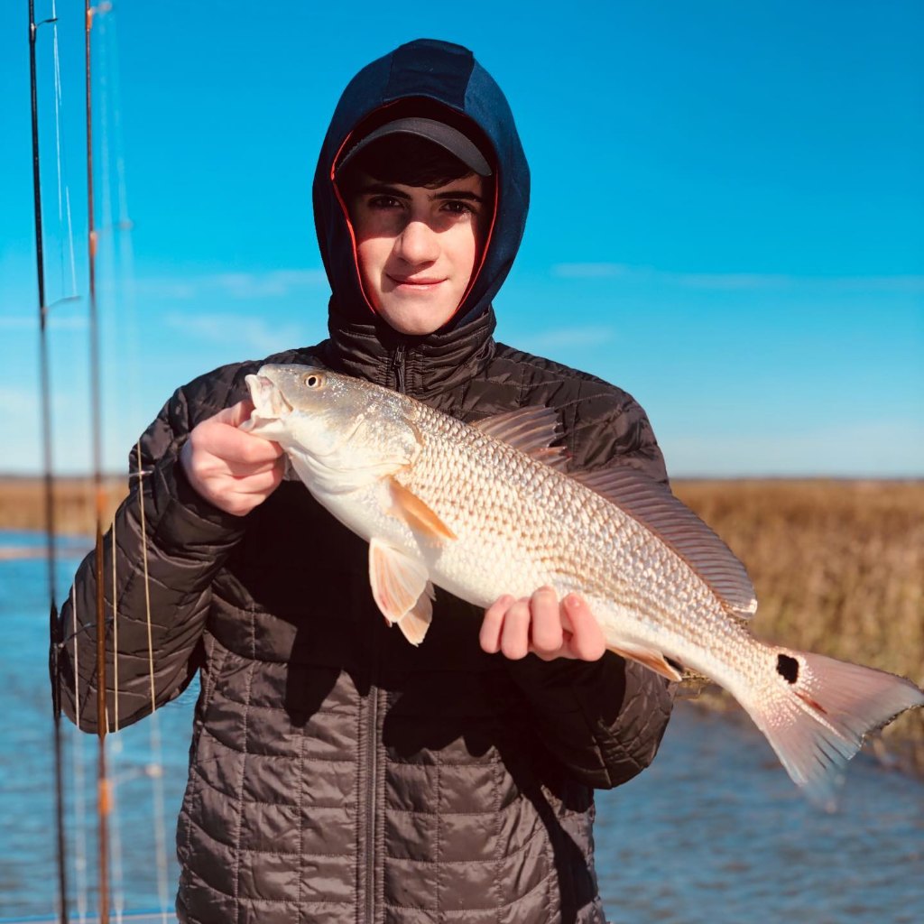 A redfish caught by two people in Mount Pleasant