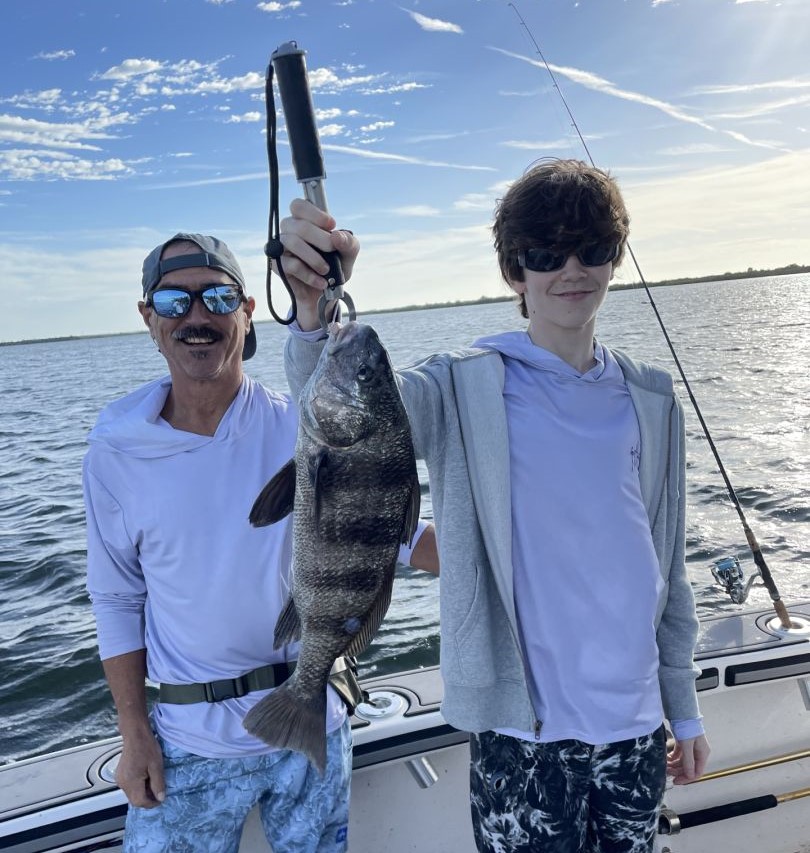 Fisherman with large black drum fish catch in FL