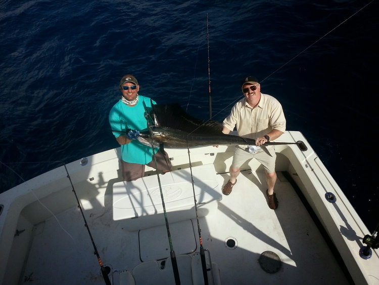 Anglers catching a large fish while fishing in Pompano Beach