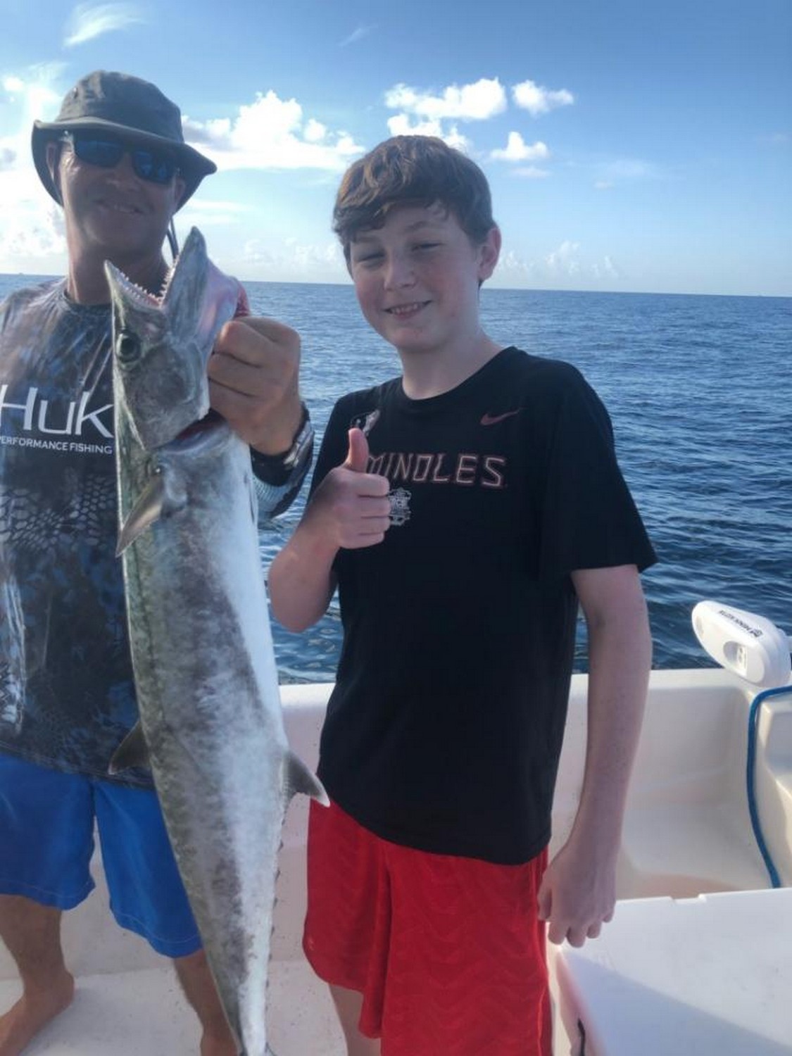A fisherman holding a large king mackerel catch in Panama City