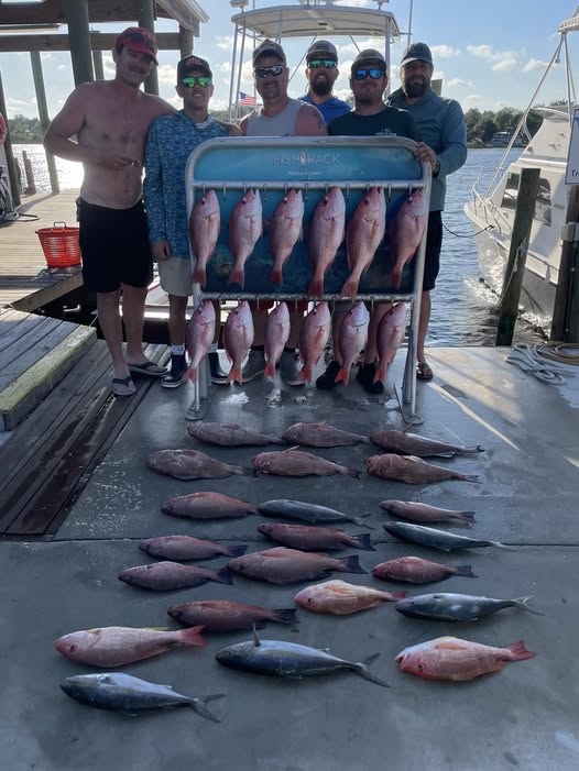 Fishing charter display of red snapper and yellowtail amberjack catch on dock in Panama City Beach FL