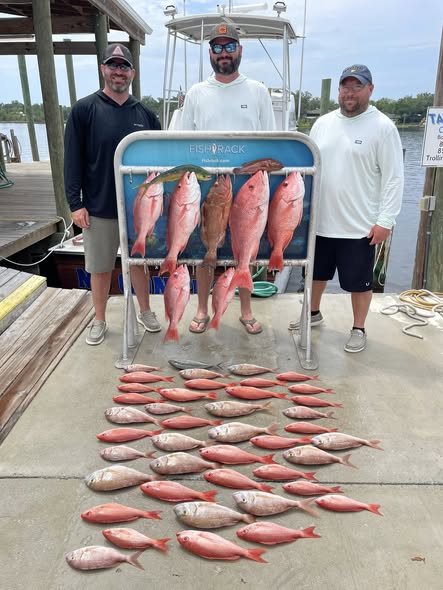 Red snapper fishing catch displayed on dock at Panama City Beach FL with fish rack and boat