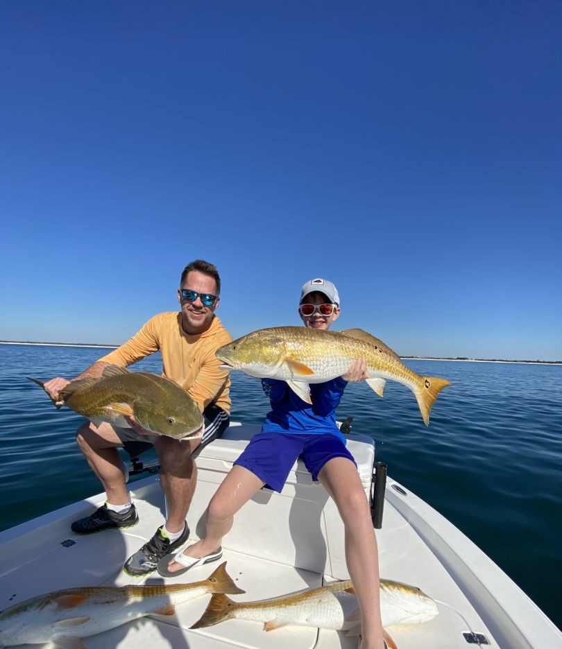 Two anglers with a pair of big fish caught in Orange Beach