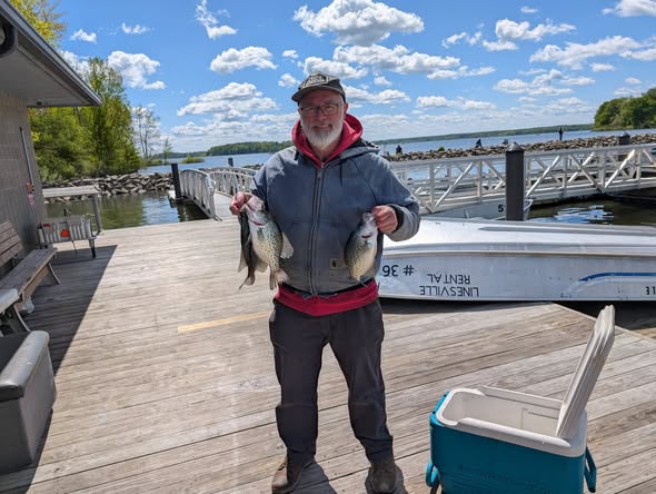 Freshly caught fish displayed on dock at Foxburg PA marina with boat in background