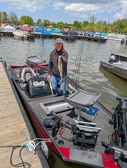 Angler holding walleye fish on fishing boat at marina in Foxburg PA
