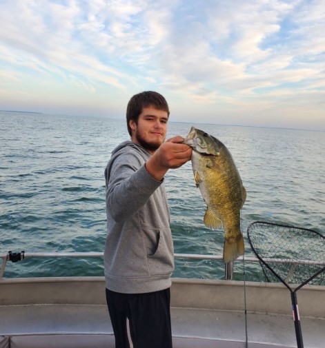A person fishing in the waters of Oak Harbor
