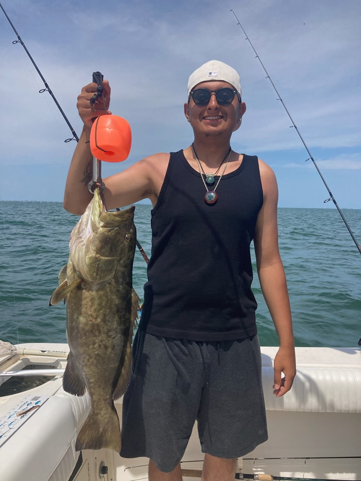 Angler with a massive Gag Grouper fish caught in Palmetto