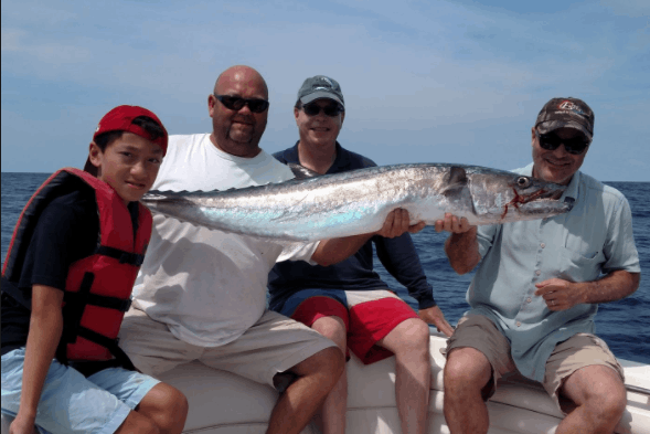 A group of 4 people fishing at Wrightsville Beach