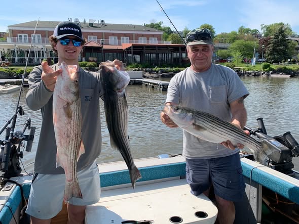 Successful striped bass fishing trip in Mexico NY showing multiple caught fish on boat