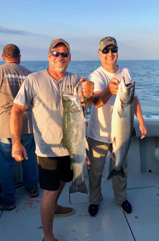 Two anglers fishing in Manistee with 2 big fish