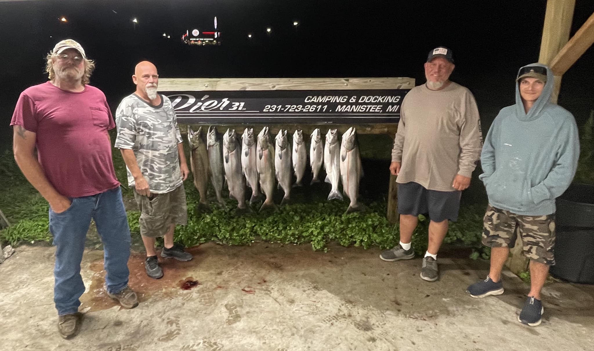 Four people enjoying a fishing trip in Manistee