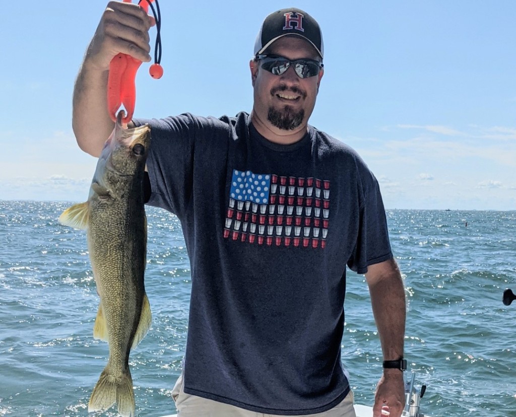 A person fishing at a lakeside location