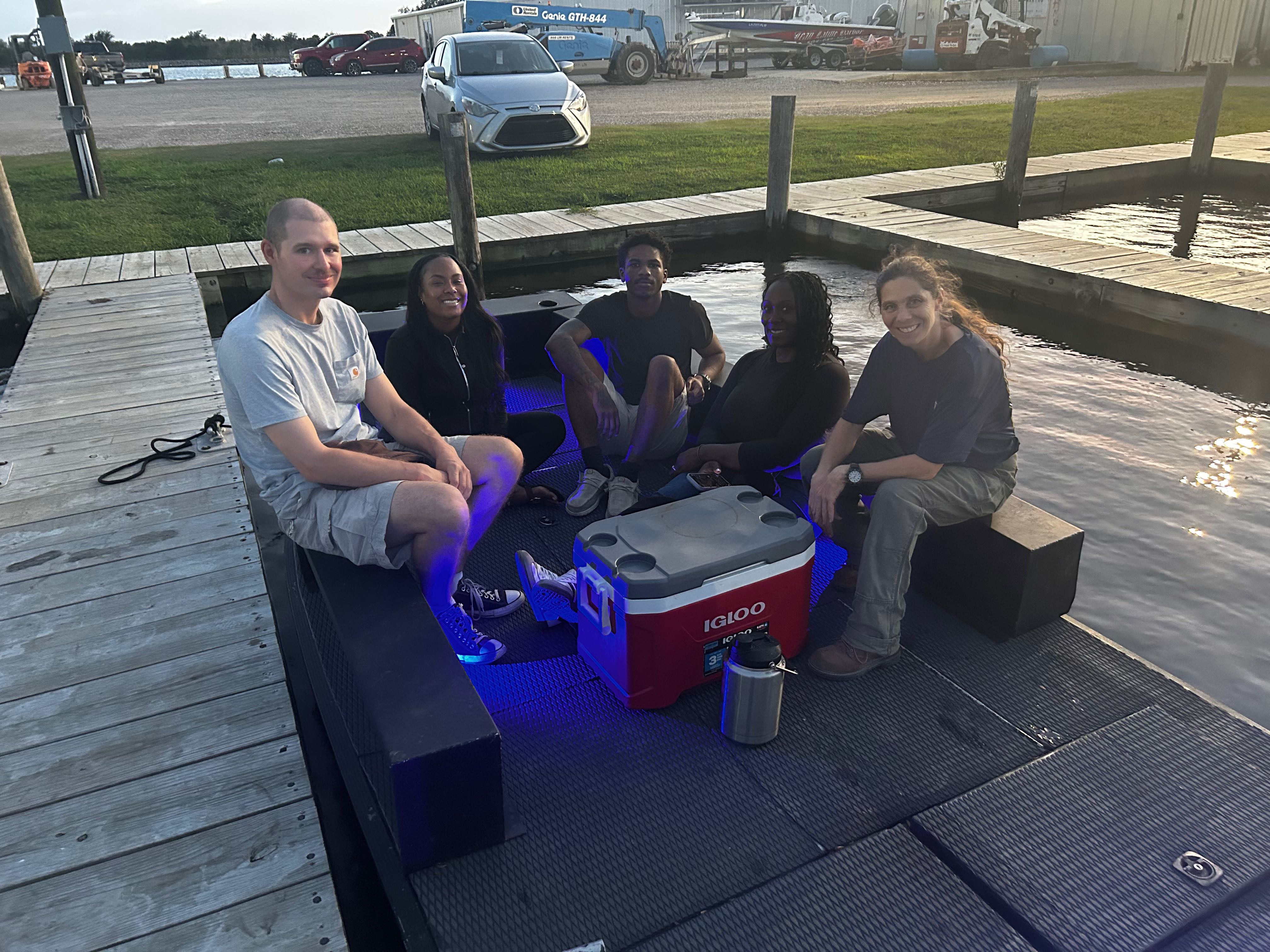 Group relaxing on dock with cooler in Lafitte LA fishing area