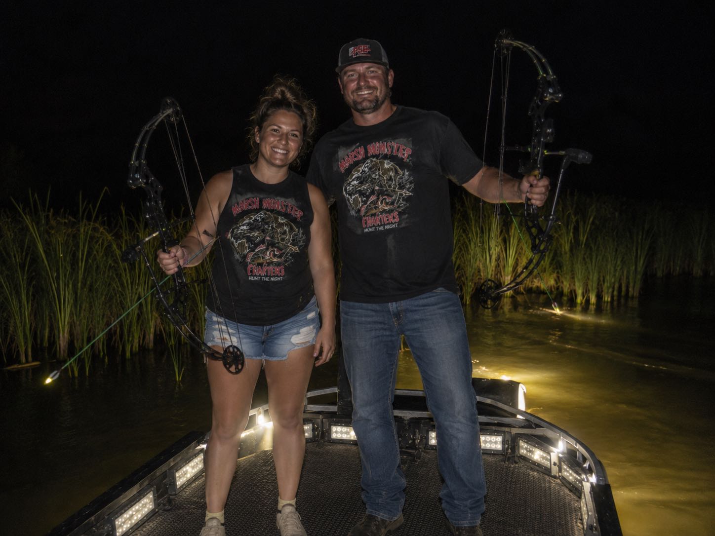 Lafitte Louisiana night bowfishing charter boat targeting redfish in Barataria Basin marshes
