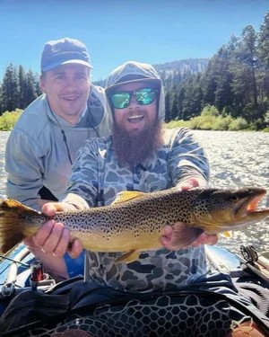 Fly fishing guide leading anglers wade fishing Willow Creek Alaska for trout grayling salmon