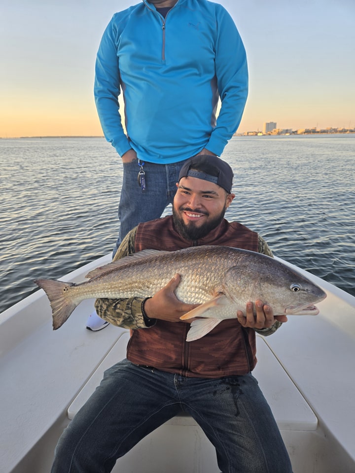 Charleston SC redfish catch on fishing boat during sunset