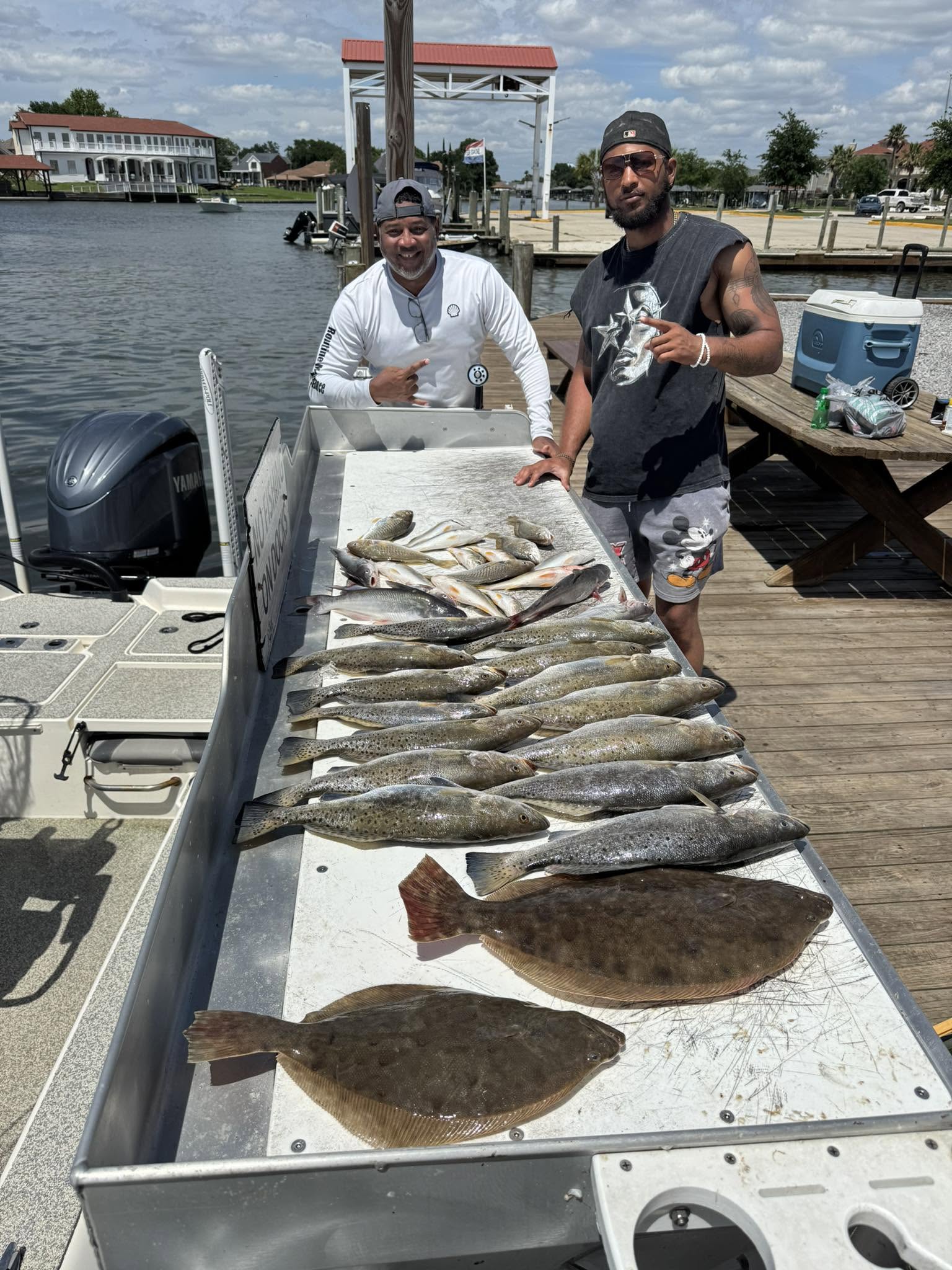 Successful fishing trip in Slidell LA showing Southern Flounder and Speckled Trout catch displayed on boat