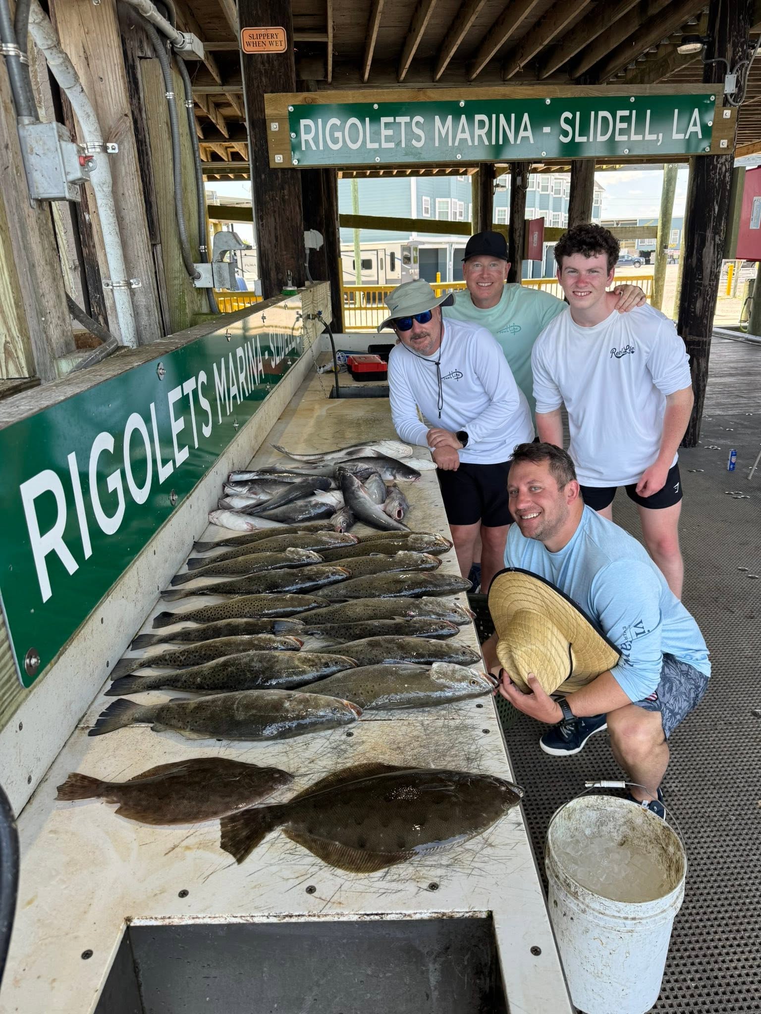 Successful fishing trip displaying multiple Southern Flounder and other fish species at Rigolets Marina cleaning station in Slidell, Louisiana
