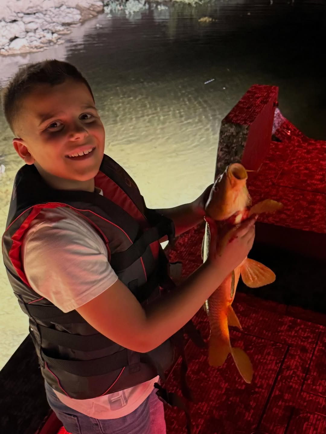 Fish catch displayed on red surface near water in Scottsdale AZ