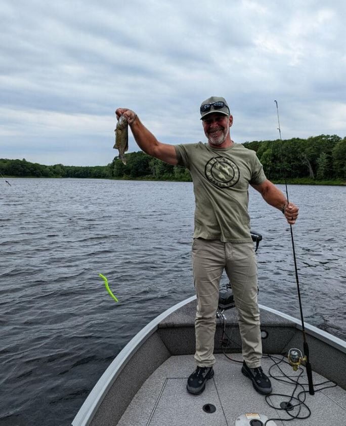 A person fishing in Orono