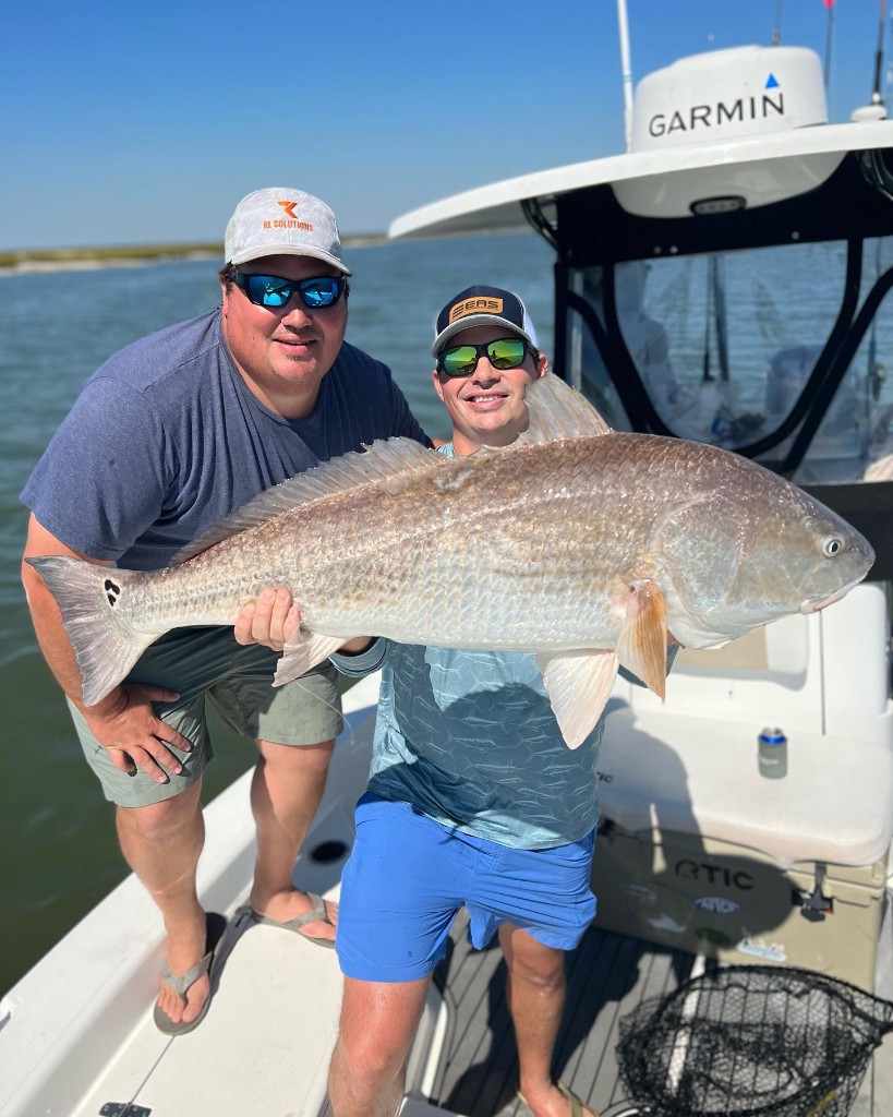 Two anglers holding a big fish in South Carolina