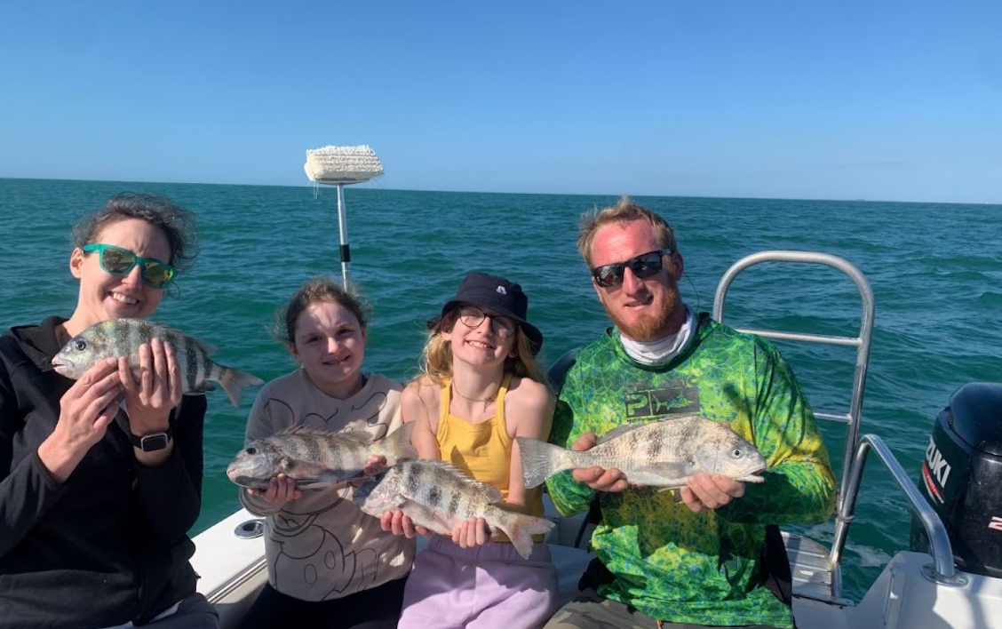 4 fishing enthusiasts enjoying a successful day at Bradenton Beach