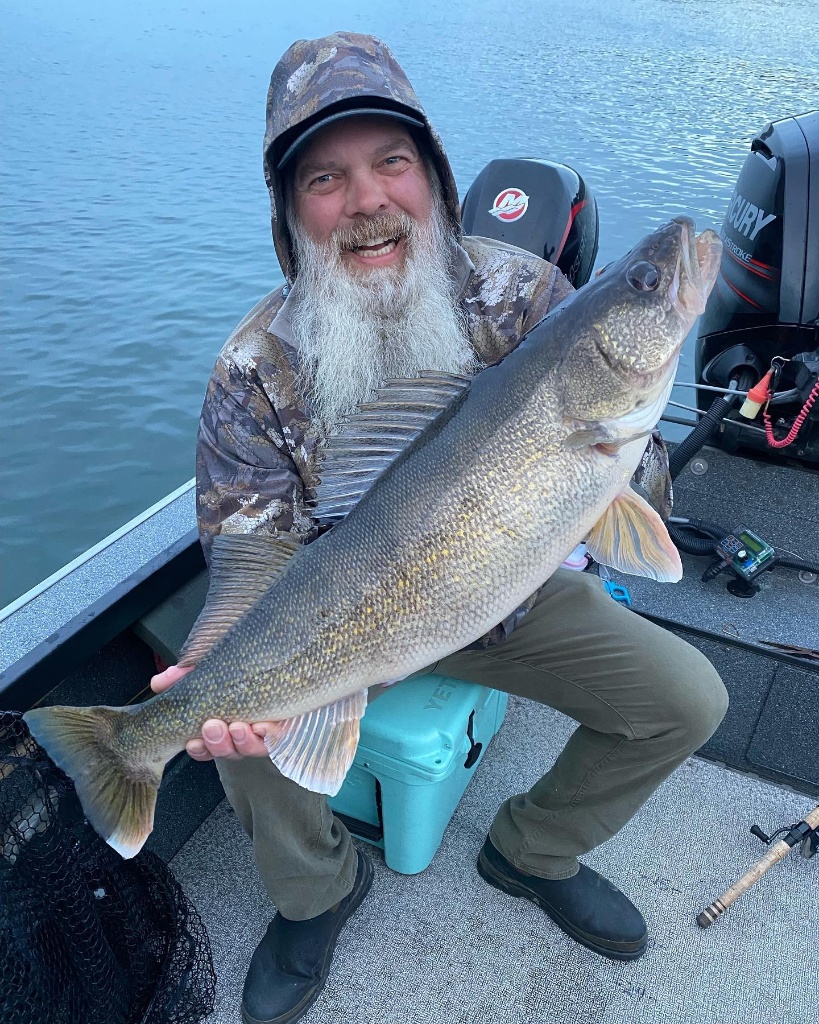 Angler holding a large walleye fish in Beaverton