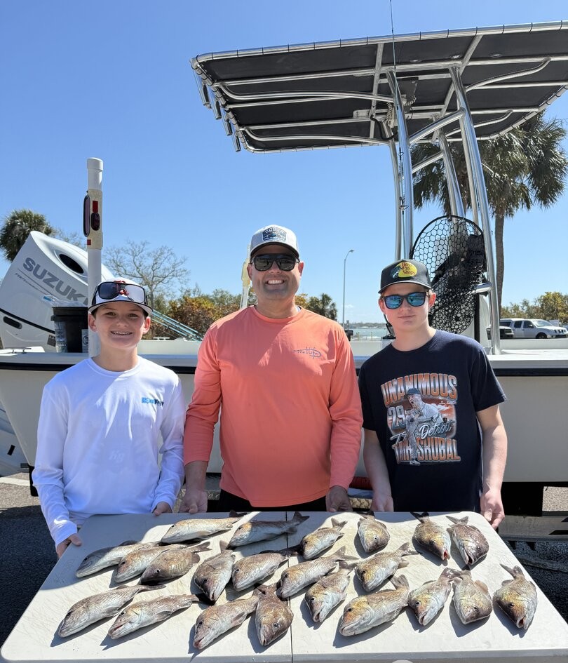 Successful fishing trip in St. Petersburg FL with large catch of fish displayed on table