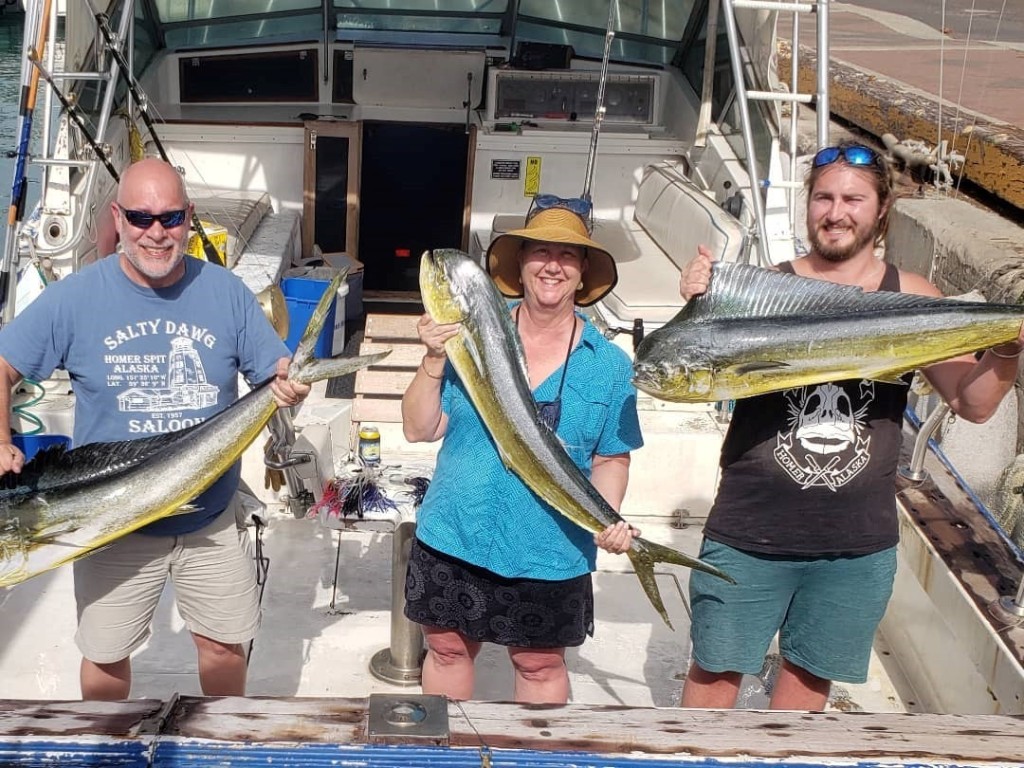Family fishing in Hawaii with 2 large fish