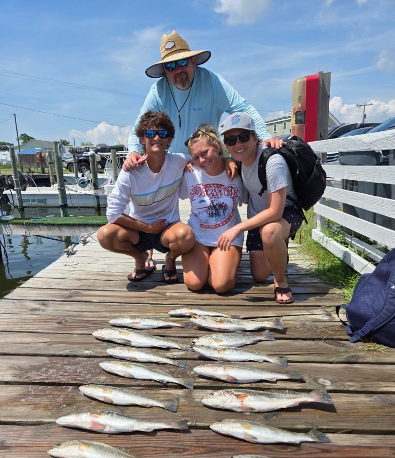 Fishing charter catch display on dock in Wanchese NC with multiple fish species laid out