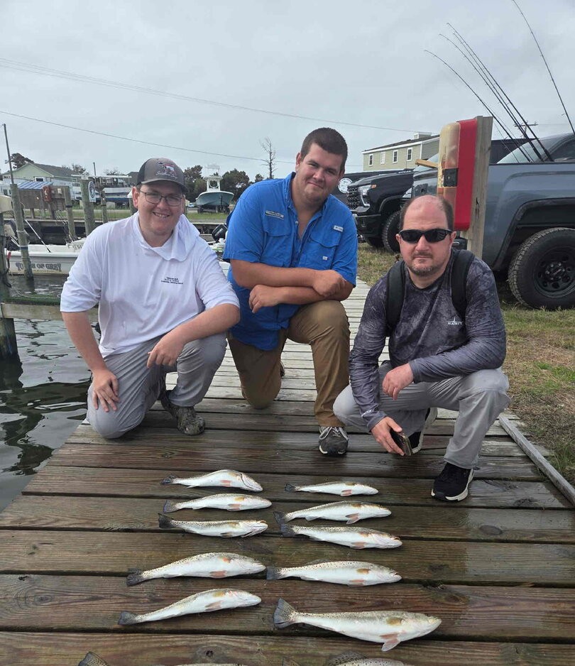 Successful fishing trip in Wanchese NC with multiple caught fish displayed on wooden dock