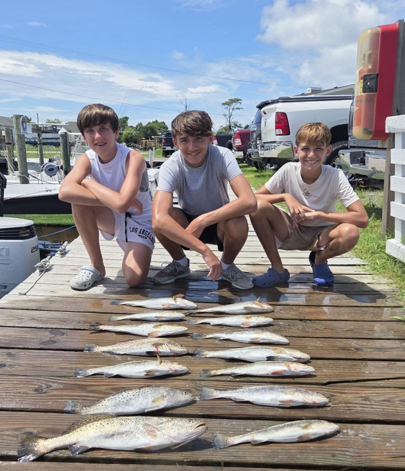 Successful fishing trip in Wanchese NC showing speckled trout catch on wooden dock