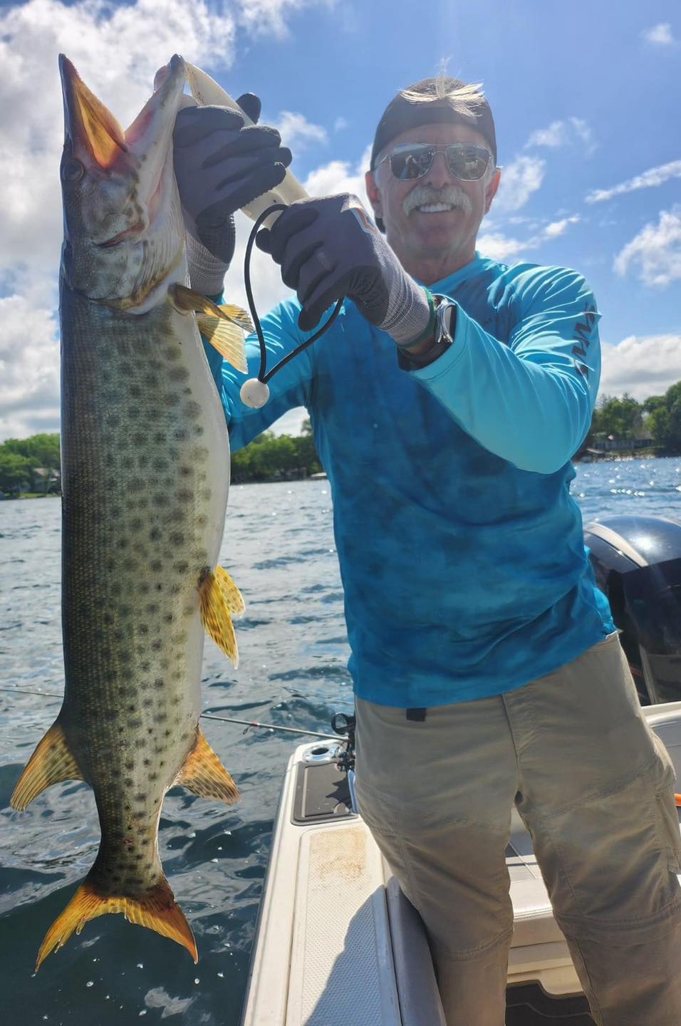 Muskellunge catch held on fishing boat in Spring Park Minnesota