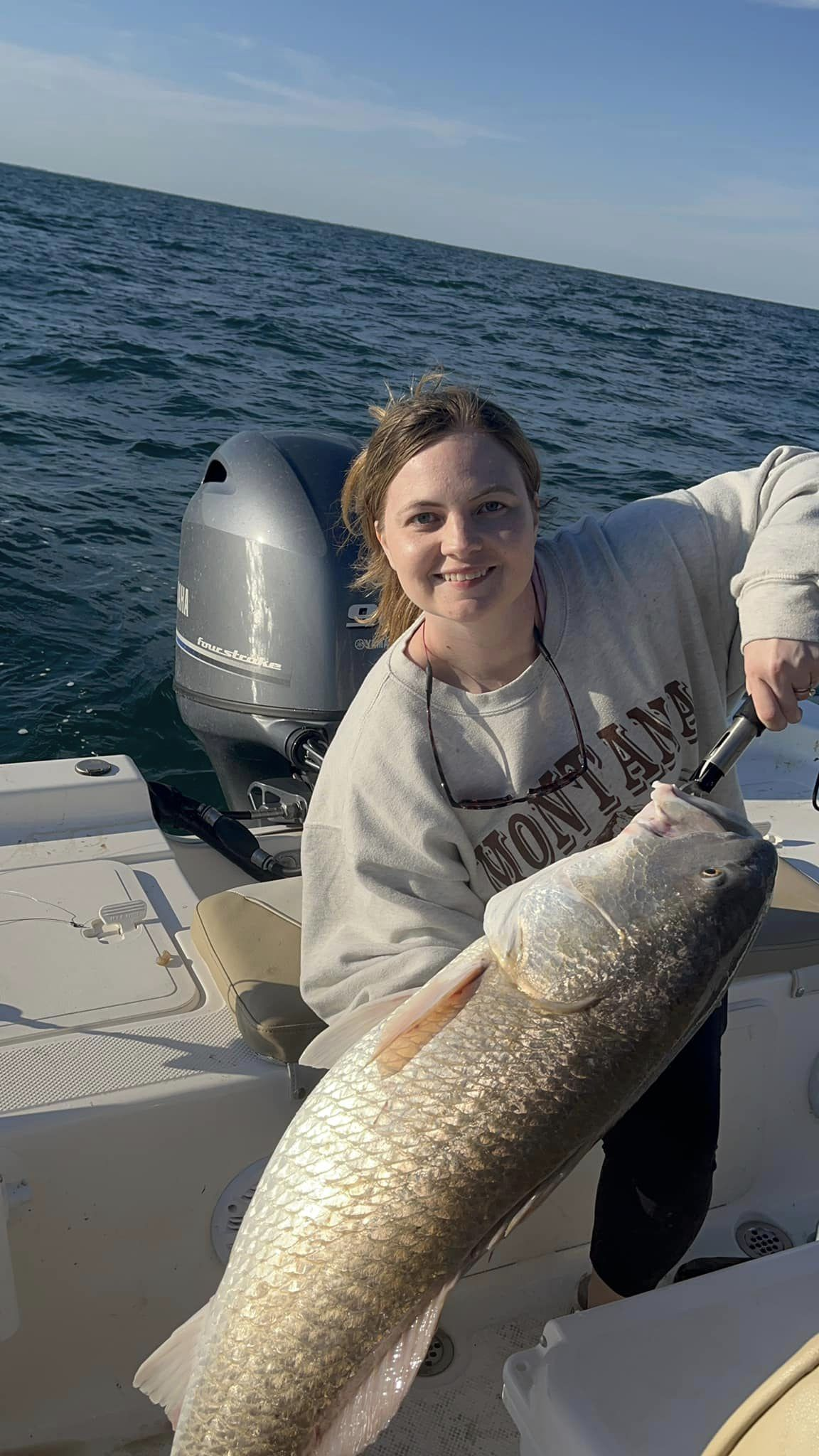 A fisherman holding a 19-inch fish in SC