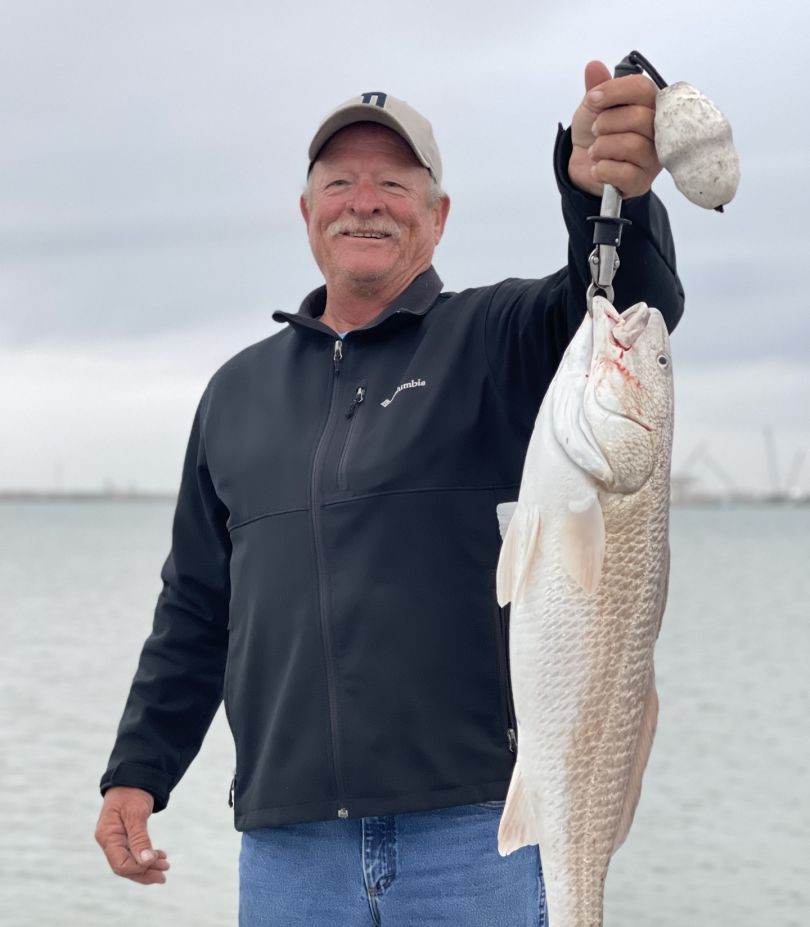 Angler holding large redfish caught in Aransas Pass TX