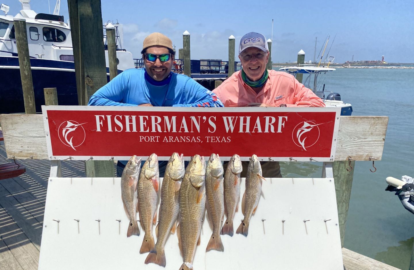 Fishing charter catch of six redfish displayed at Fisherman's Wharf in Aransas Pass TX