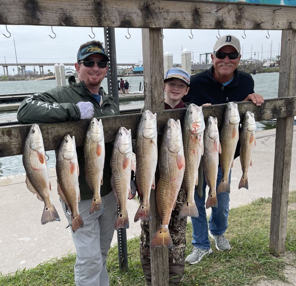 Ten redfish hanging on display at fishing dock in Aransas Pass Texas