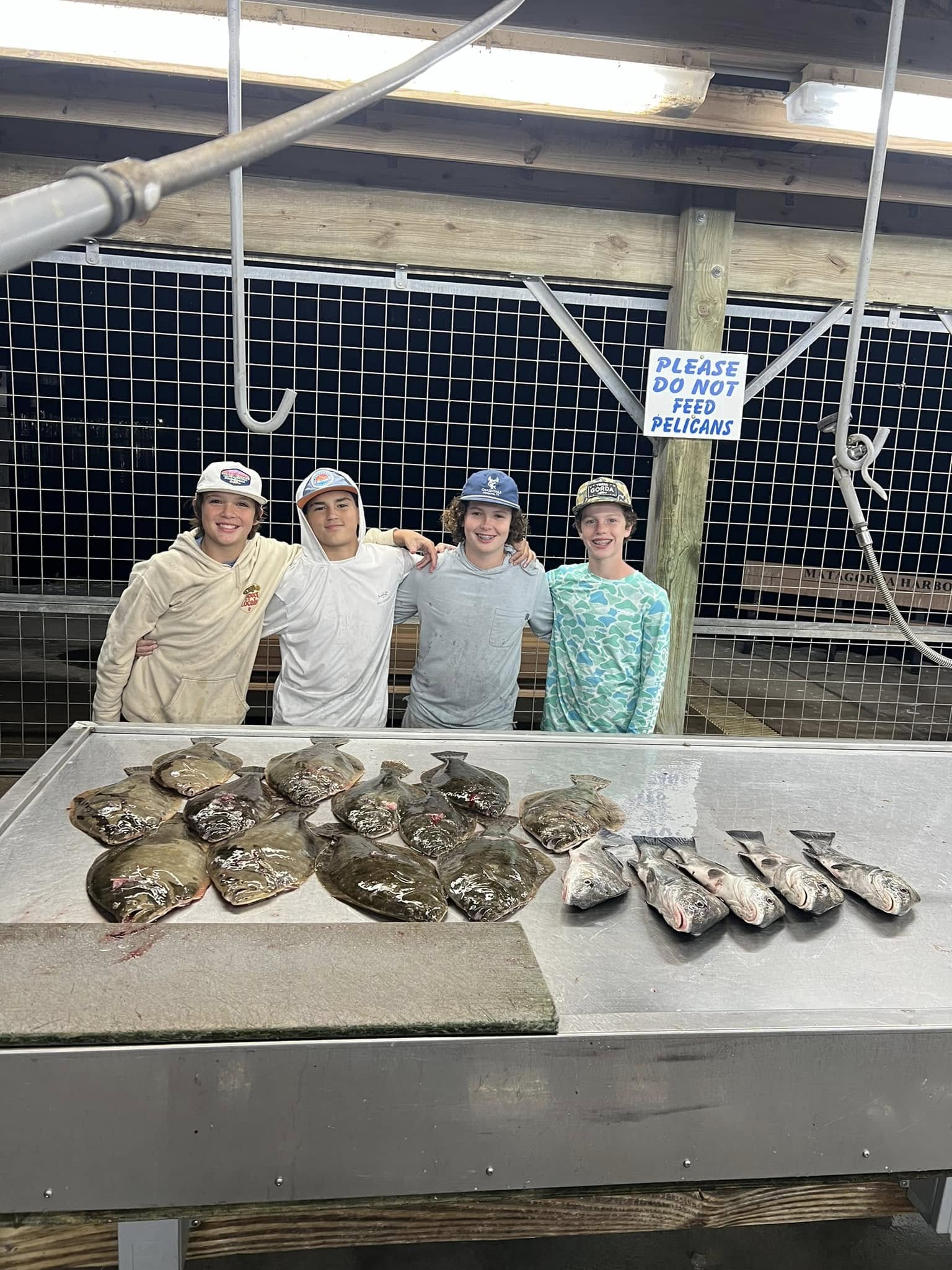 Fish cleaning station with fresh caught flatfish and other species laid out on cleaning table in Matagorda TX