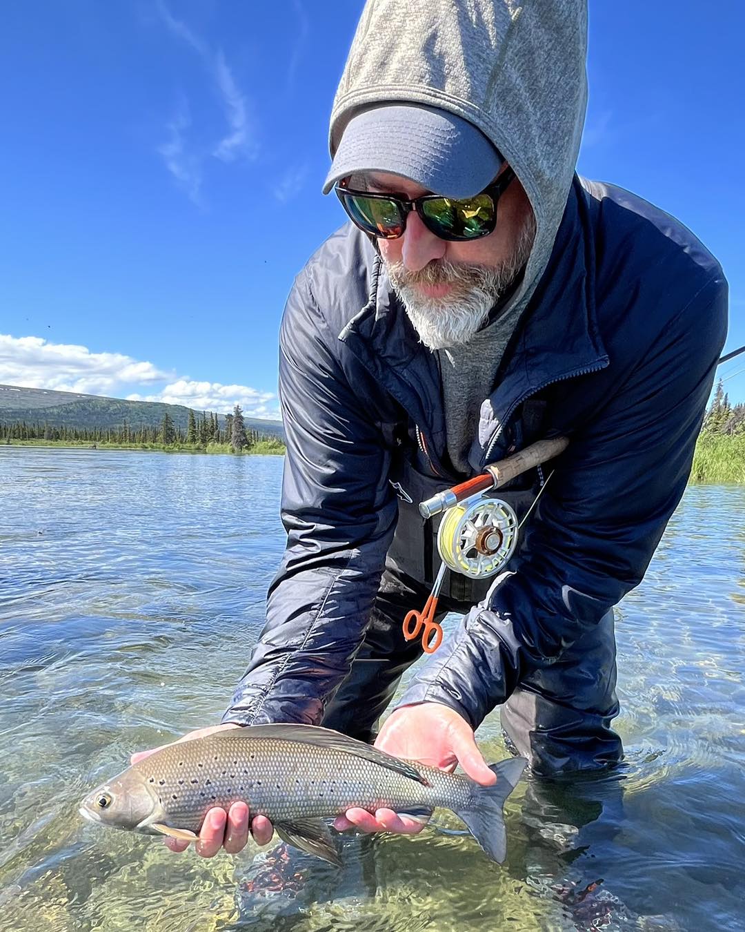 Angler with an Arctic Grayling fish caught near Soldotna